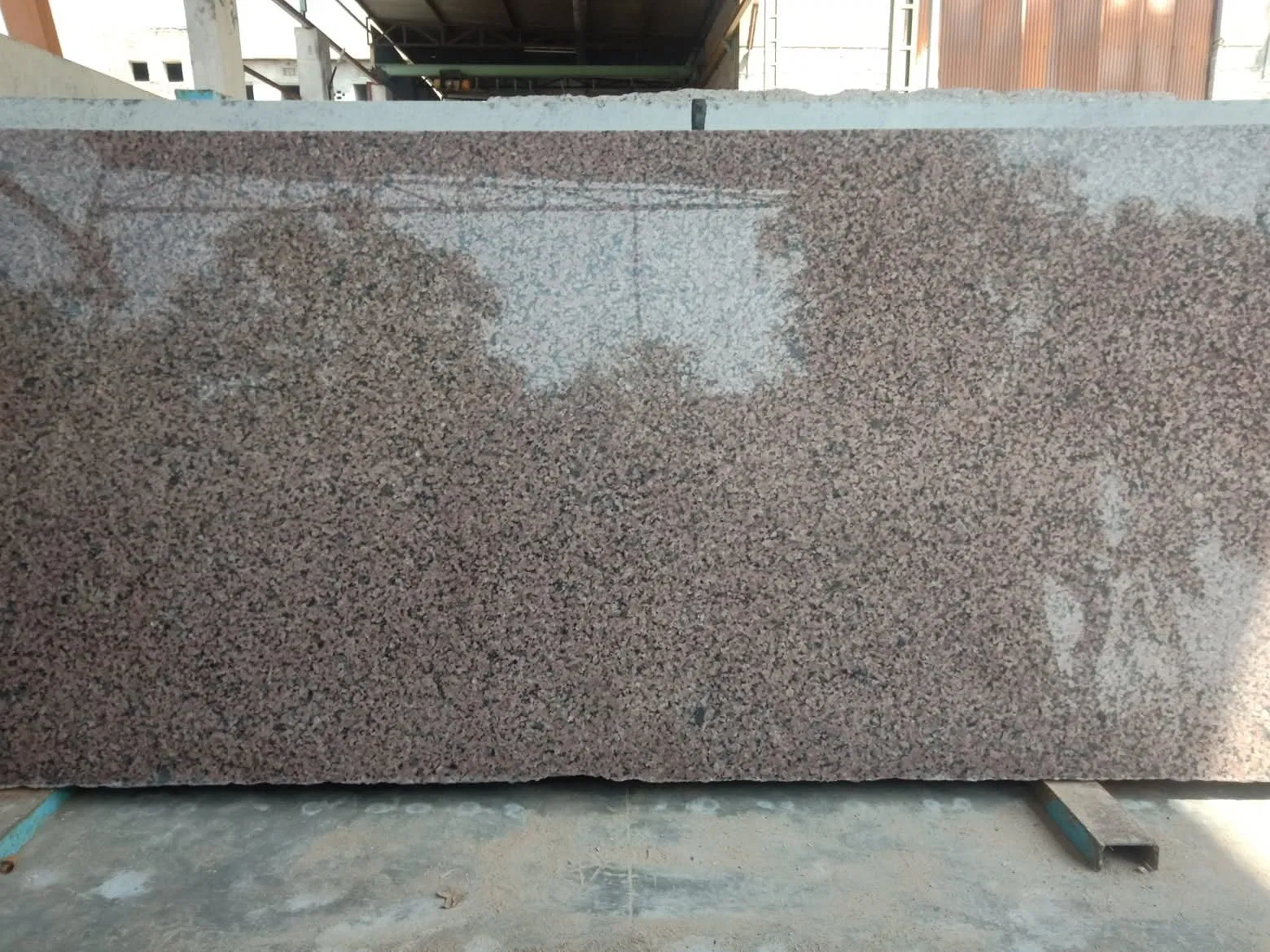 Polished large-format granite slab displaying a consistent pink and black granular pattern, processed for export. Ideal for large-scale architectural projects requiring high-quality finishes.