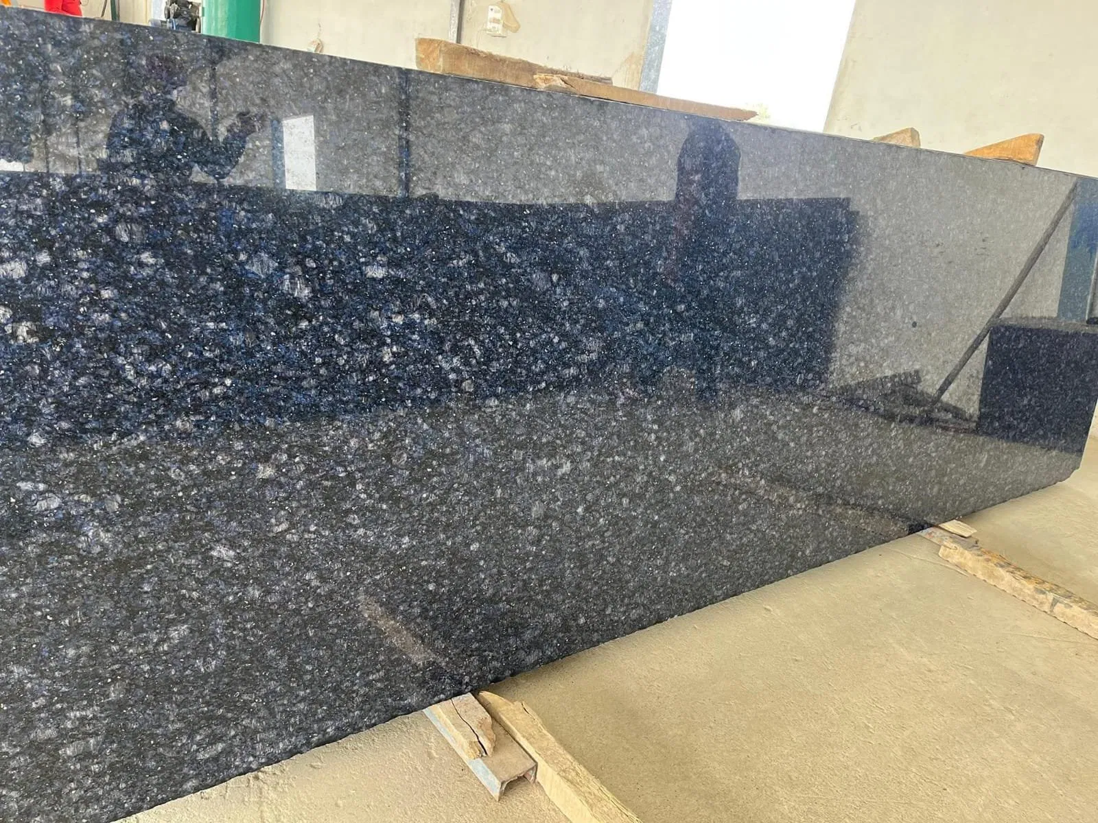 Himalayan Blue Granite: Scaling High-Altitude Aesthetics for Coastal Resort Projects 3 Polished Blue Pearl Granite slab featuring iridescent silver and blue flecks, ideal for comparison with the swirling Himalayan Blue.