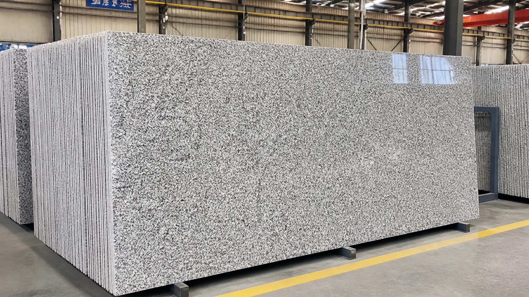 Export Intelligence: How to Source Premium Granite Slabs from India Without Logistics Headaches 4 High-quality granite slabs with a consistent grey and white granular pattern and polished surface finish. The slabs are precision-cut, ready for export, and suitable for countertops, flooring, and architectural applications.
