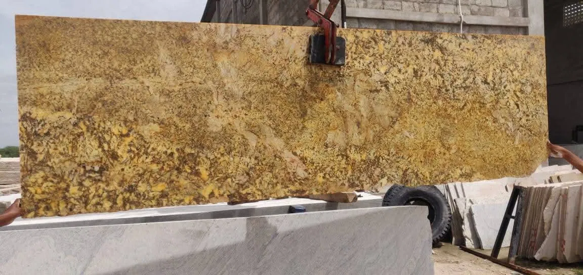 Exporting Excellence: How Stone Harbor Ensures Quality in Every Slab 1 A yellow granite slab being handled at the processing yard showing uniform thickness and vibrant color