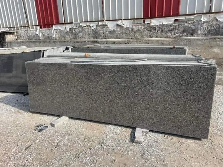 Warmth & Durability: Why Z Brown Granite is Outperforming Synthetics in High-End Kitchens 4 High-quality polished granite slabs stacked in the Stone Harbor Exports yard ready for shipment