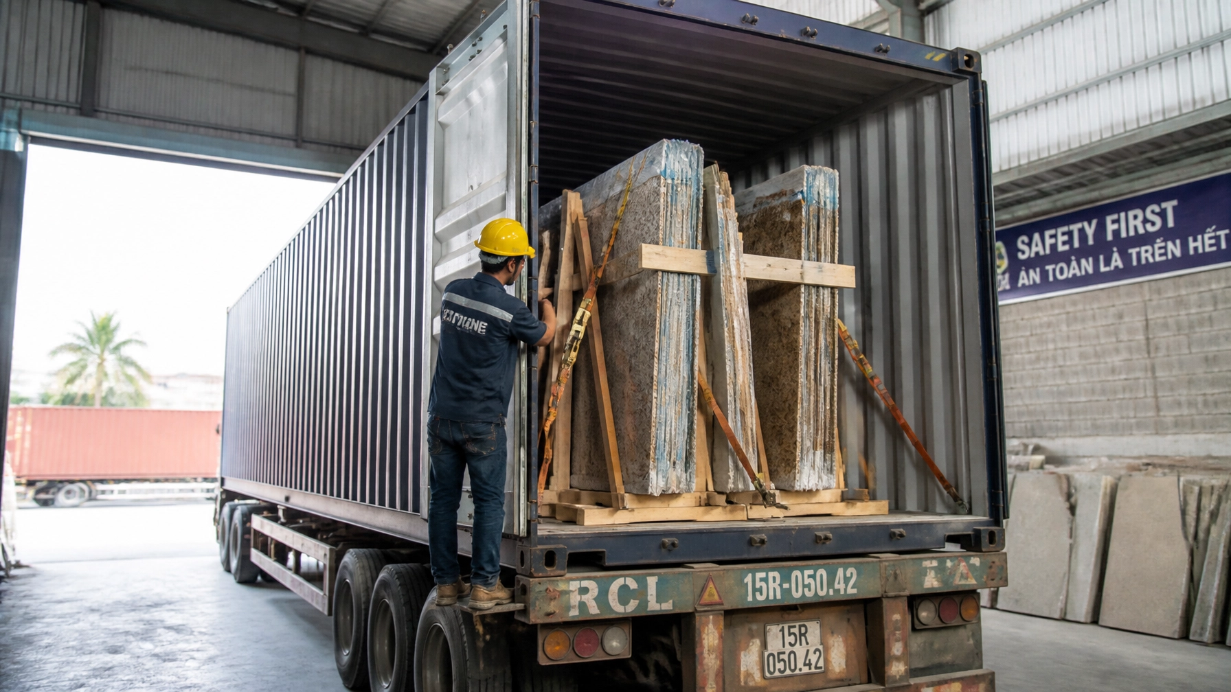 Export Intelligence: How to Source Premium Granite Slabs from India Without Logistics Headaches 3 A detailed view of a 20-foot shipping container being professionally loaded with granite slabs secured on heavy-duty wooden A-frames, with industrial bracing and straps ensuring stability for sea freight.