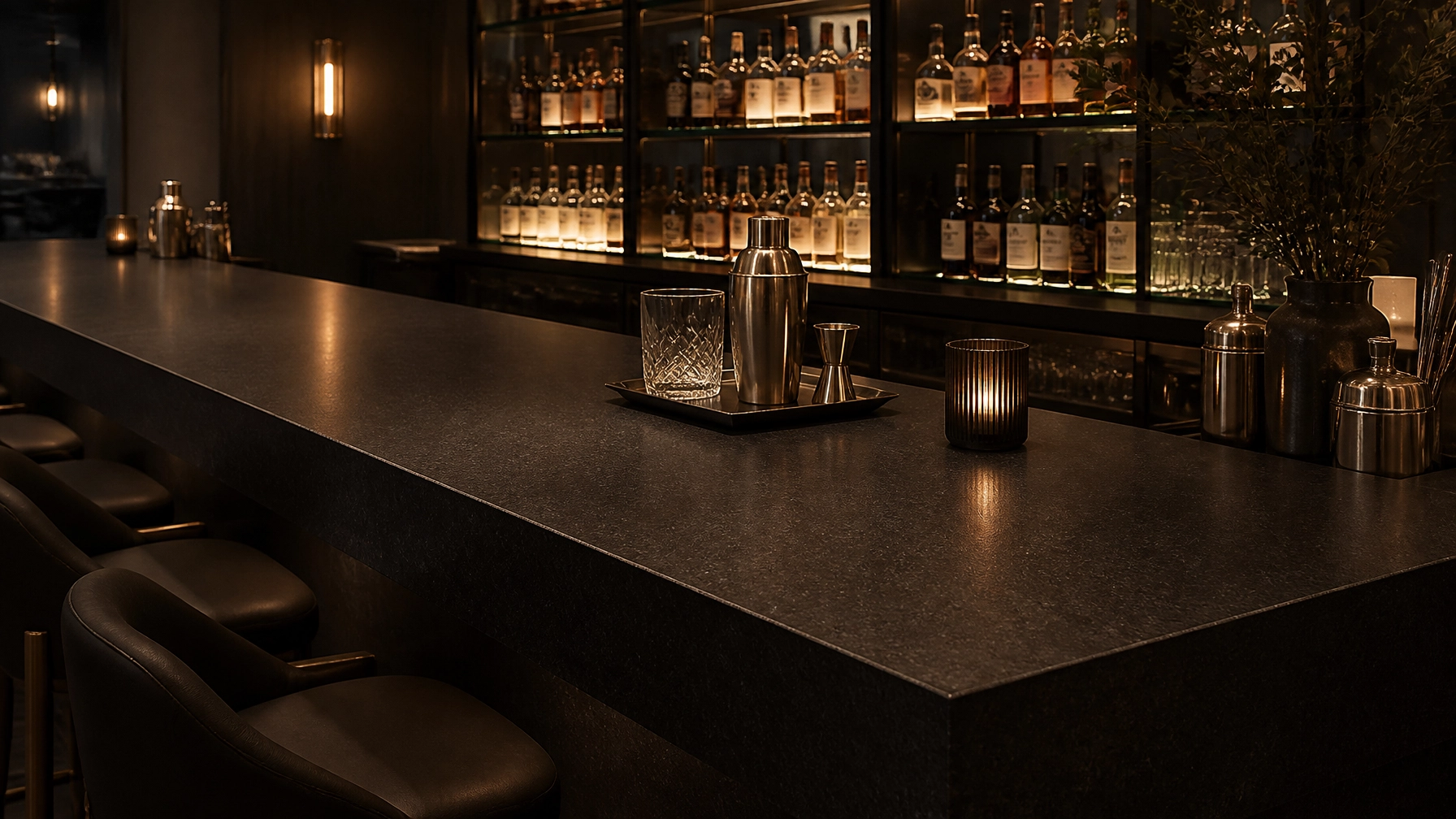 The Texture Revolution: How Leathered Black Forest Granite is Redefining Commercial Interiors 2 An upscale cocktail bar with a Leathered Black Forest Granite bar top, embodying the Quiet Luxury trend.