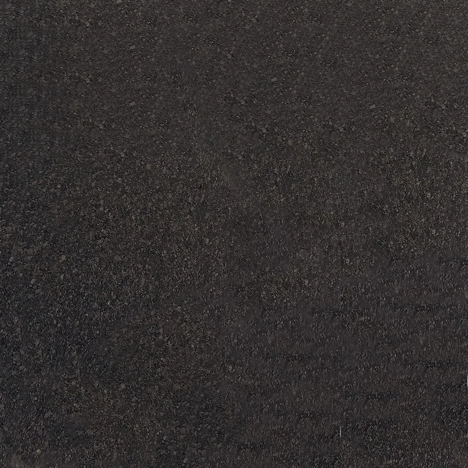 Dark Elegance: Navigating the Grading Systems of Black Granite Stone for International Buyers 2 Close-up of black granite with subtle mineral flecks, demonstrating the