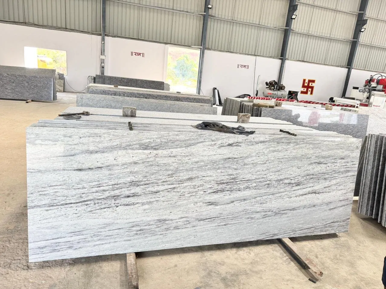 2026 Kitchen Design Trends: Why White Granite Still Reigns Supreme 1 Batch of large, polished white granite slabs prepared for export at Stone Harbor Exports