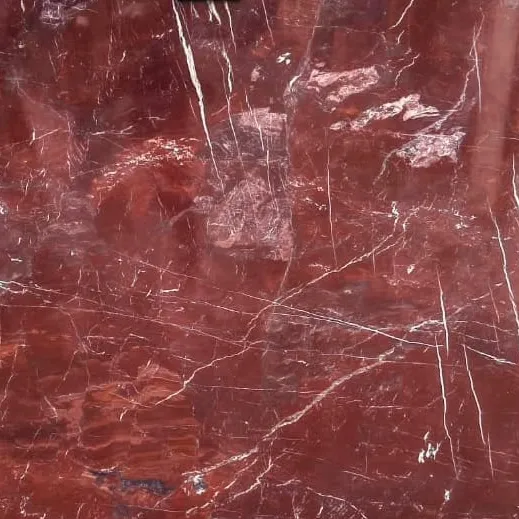 Coral Red Marble close-up, rich coral red with white veining and breccia patches, Stone Harbor Exports