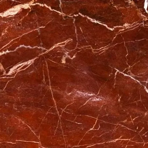Jasper Red Marble close-up, deep oxblood red with flowing bands and white veining, Stone Harbor Exports