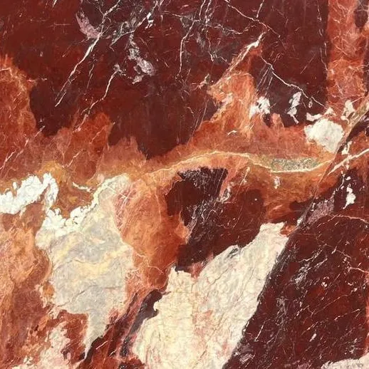Rouge du Roi Marble close-up, deep red with sweeping orange-coral and cream-white patches, Stone Harbor Exports